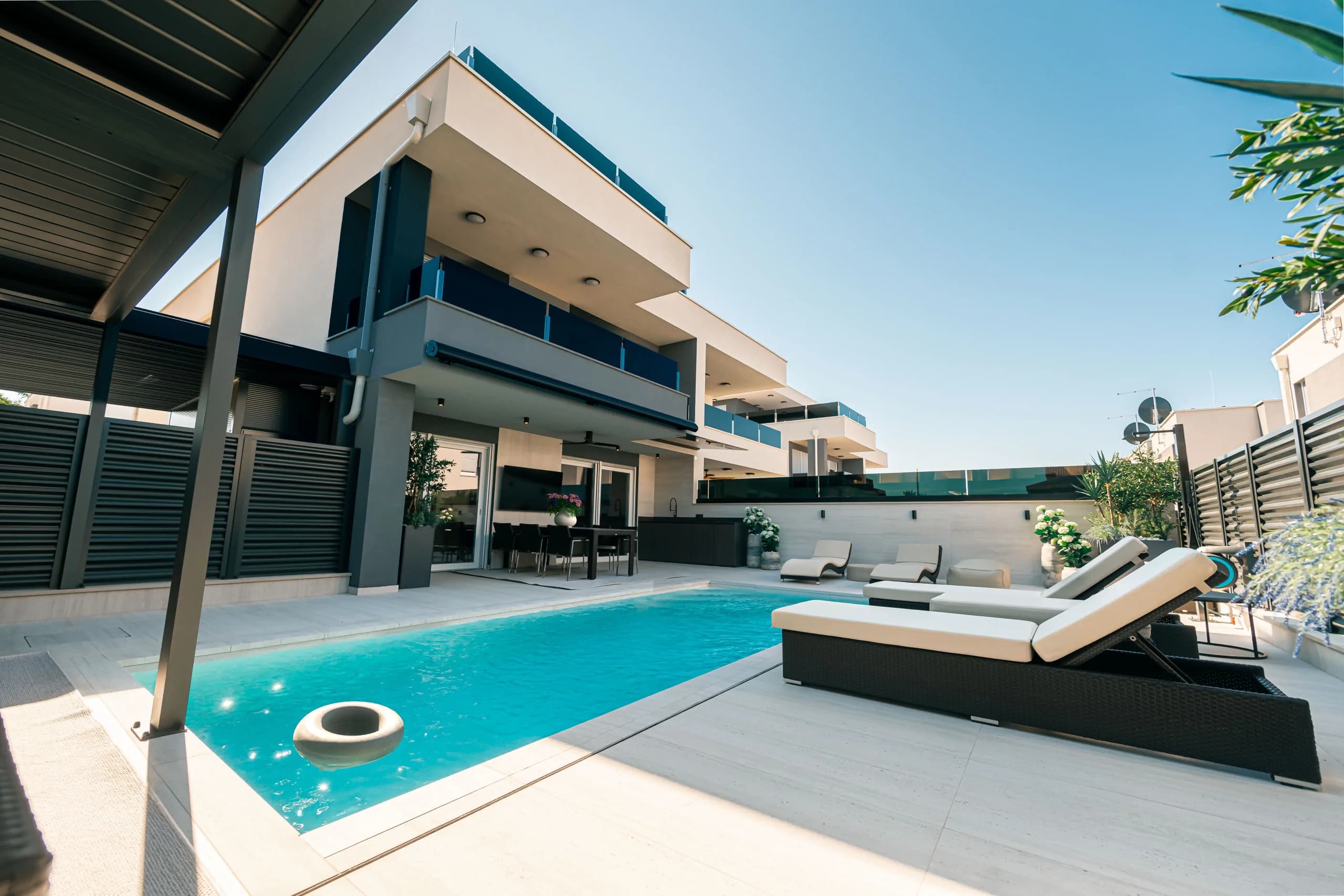 Velora's rooftop terrace and heated pool at dusk
