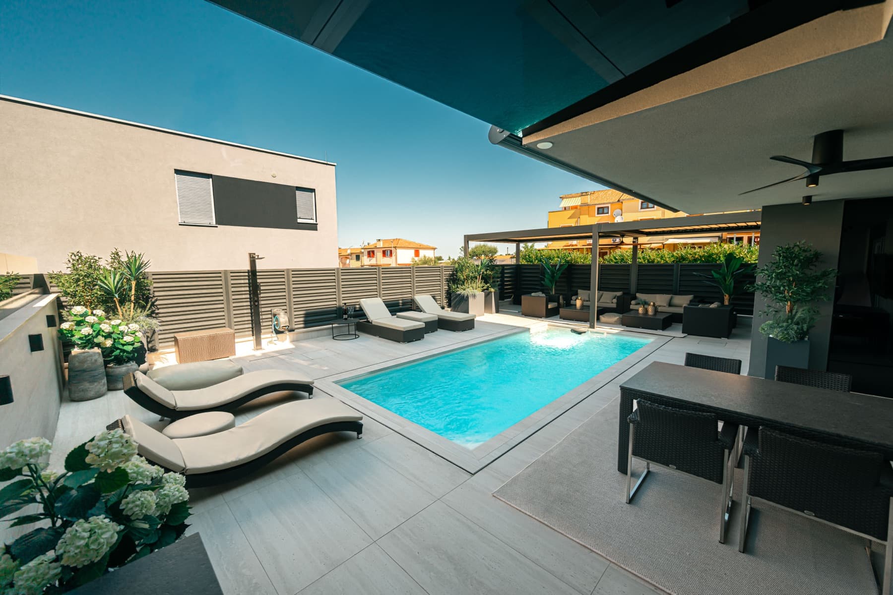 Velora's rooftop pool and lounge area in daylight